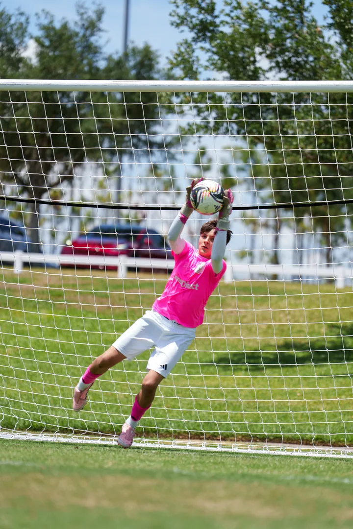 Gavin catching the ball above his head beside the goal