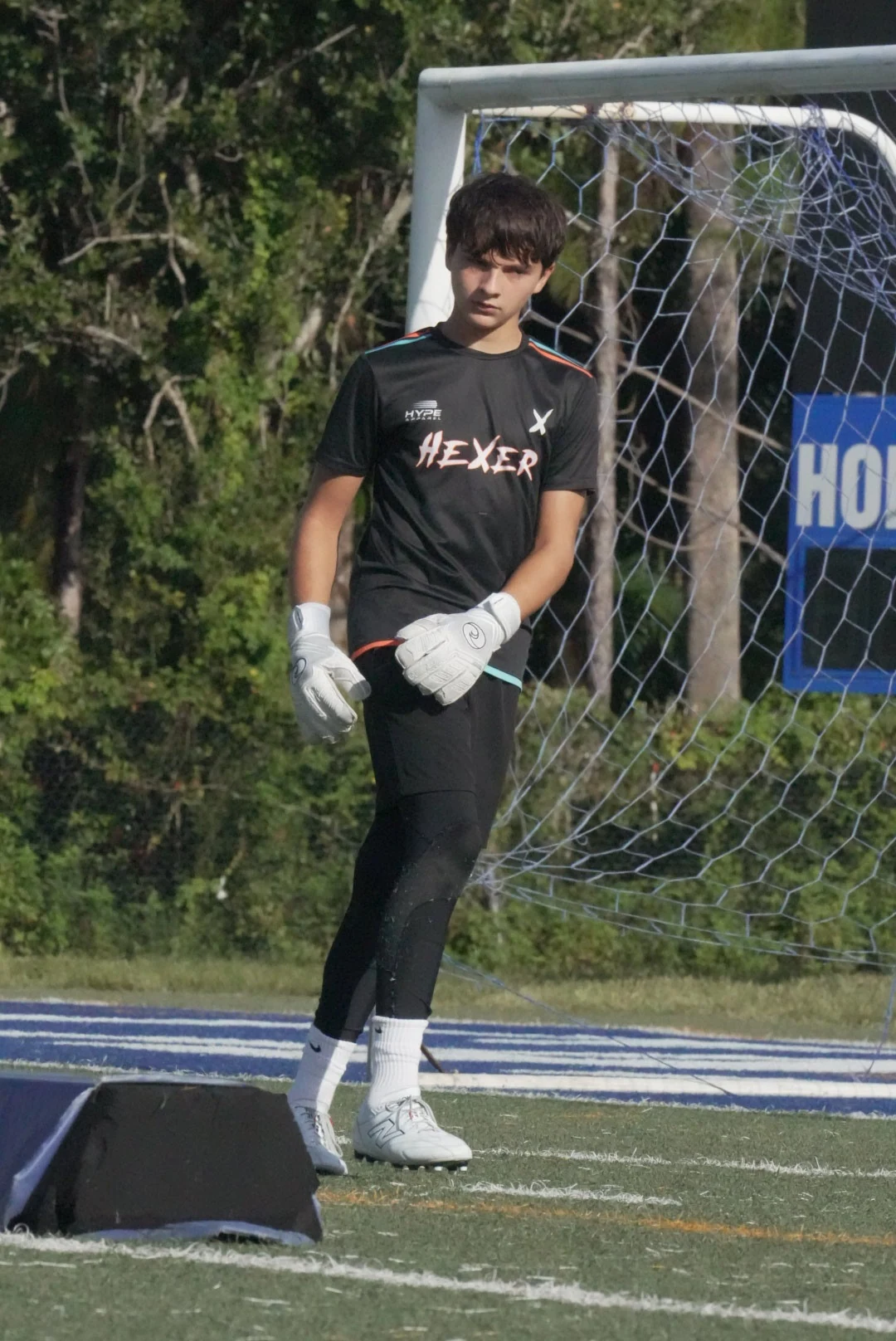 Gavin in his goalkeeper kit and gloves beside the goal