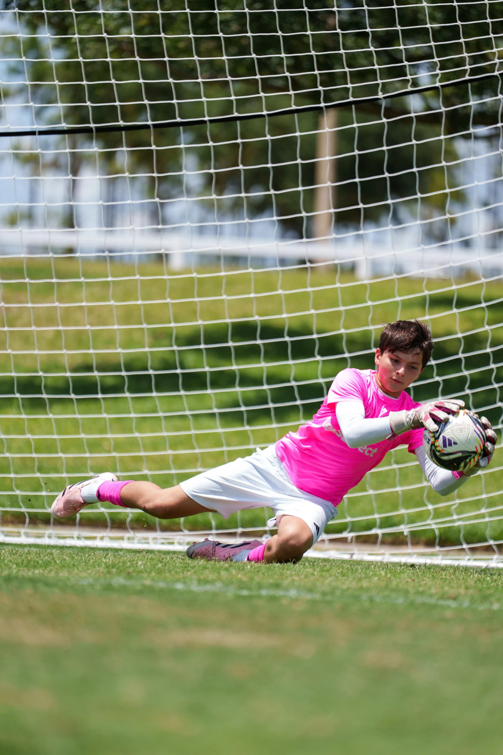 Gavin diving to catch a ball in front of the goal