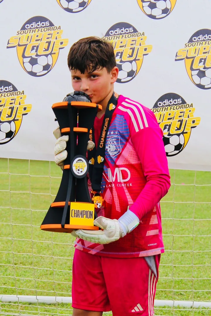 Gavin holding the South Florida Super Cup champions trophy